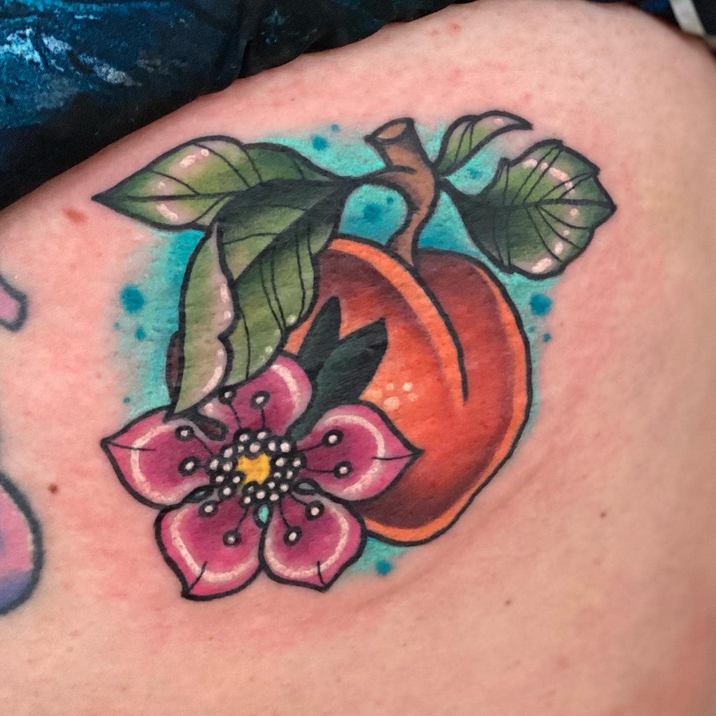Watercolor tattoo of a peach with leaves and a pink flower